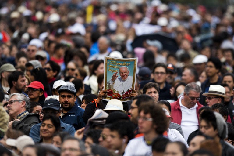 Faithful await for the passage of Pope Francisco in Quito, Ecuador, on July 5, 2015.  Pope Francis arrived in Ecuador on Sunday to kick off his first South American trip in two years that will also take him to Bolivia and Paraguay and see him highlight the plight of the poor.  AFP PHOTO / LUIS ROBAYO