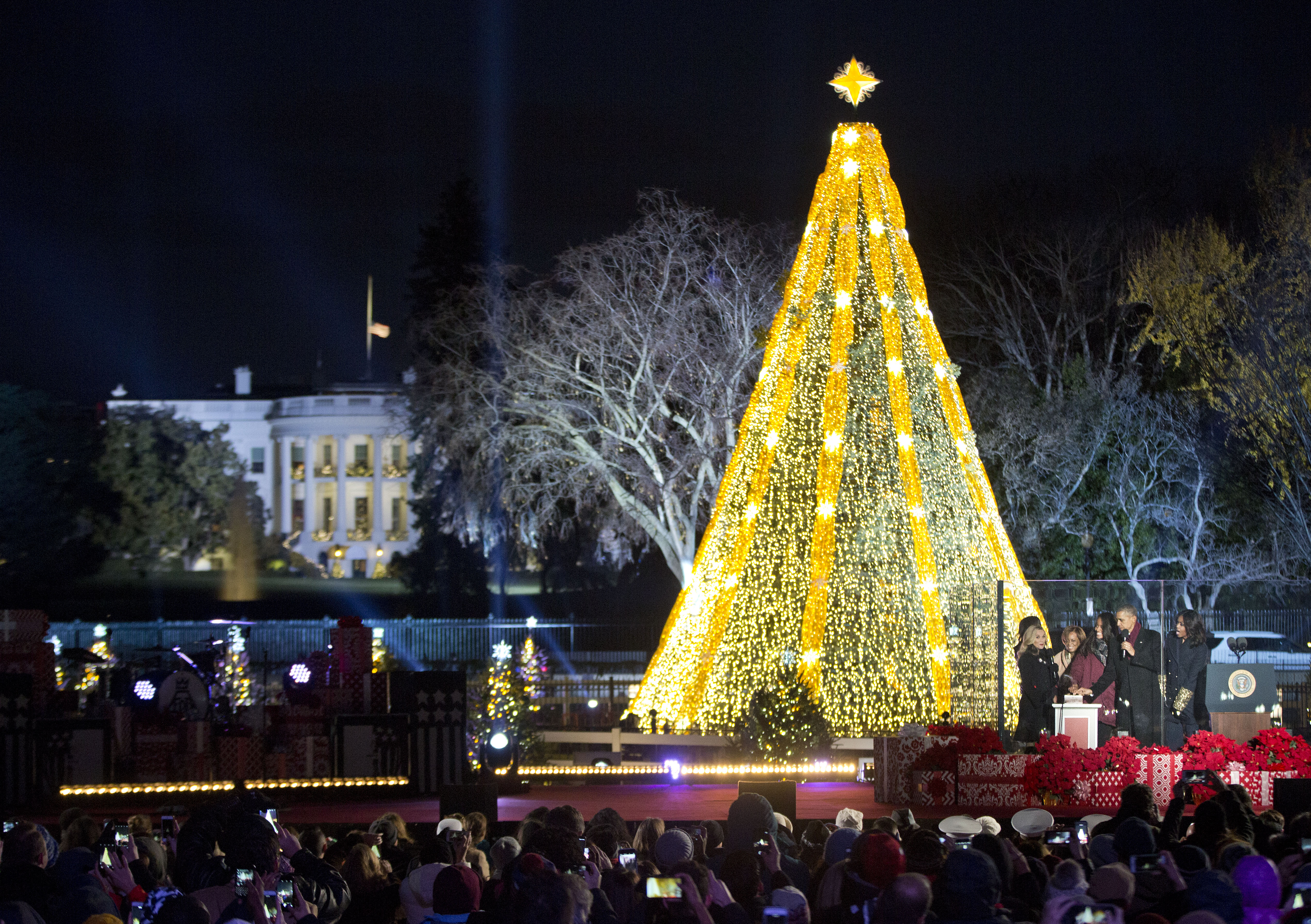 President Barack Obama, first lady Michelle Obama, and their daughters Sasha, and Malia, and Michelle's mother Marian Robinson, react as they light the National Christmas Tree during the National Christmas Tree Lighting ceremony at the Ellipse in Washington, Thursday, Dec. 3, 2015. On the far left on stage is actress Reese Witherspoon. (AP Photo/Pablo Martinez Monsivais)