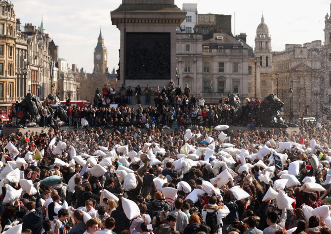 LONDON, ENGLAND - APRIL 06: Revellers take part in a giant pillow fight in Trafalgar Square on 'International Pillow Fight Day' on April 6, 2013 in London, England. Mass public pillow fights have been arranged in numerous cities around the world as part of the 'Urban Playground Movement' which facilitates free, public non-commercial events. (Photo by Oli Scarff/Getty Images)