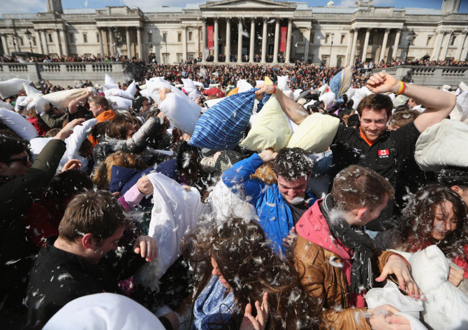 LONDON, ENGLAND - APRIL 06: Revellers take part in a giant pillow fight in Trafalgar Square on 'International Pillow Fight Day' on April 6, 2013 in London, England. Mass public pillow fights have been arranged in numerous cities around the world as part of the 'Urban Playground Movement' which facilitate free, public non-commercial events. (Photo by Oli Scarff/Getty Images)