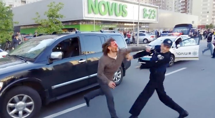 Pic shows: Vyacheslav Oliynyk fighting a cop. A former Olympic wrestling champ kept seven police officers at bay when they tried to arrest him after accusing him of drunk driving. Furious Vyacheslav Oliynyk - who won gold for Ukraine in 1996 - shrugged off pepper spray and police batons at the officers attempted to restrain him during the run-in in Kiev. And Oliynyk - who'd been celebrating his 50th birthday - showed he'd lost none of his skills since the USA's Atlanta Olympics. An extraordinary video of the catchweight bout - released by local traffic officials - shows the wrestler arguing with police over why his car was stopped. Suddenly he goes to shove one of the officers who fires a pepper spray into the former athlete's face. But instead of calming him, it just seems to make Oliynyk more angry and the officers weigh in with batons. Then - despite bleeding heavily from wounds to his head and face - the champ launches round two and comes at the officers again. It finally takes seven police officers to grapple Oliynyk - who these days seems to be a shade above his Olympic fighting weight of 90 kilos - to the ground. But even then, he keeps using his wrestling skills to prevent them from getting him in a leg lock or putting handcuffs on. Then when a female officer crouches down to talk to him and explain the arrest he replies: "Go f**k yourself." He only calms down when friends he was with tell him to go quietly for the sake of his young son who was crying in the car. Oliynyk later said he's expecting a rematch - this time in a court room. He told local newspaper Vesti: "I admit I was partially guilty, I can't tell you the whole thing. "I'm partly guilty because I did not stop and I was ignoring the police. "But I am not a criminal. As far as I can see there will be a court hearings and they will punish me somehow. "The police let me go home on the same day." (ends)