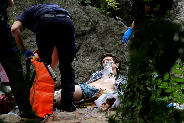 Medics stand over a man after an explosion in Central Park, Manhattan, New York