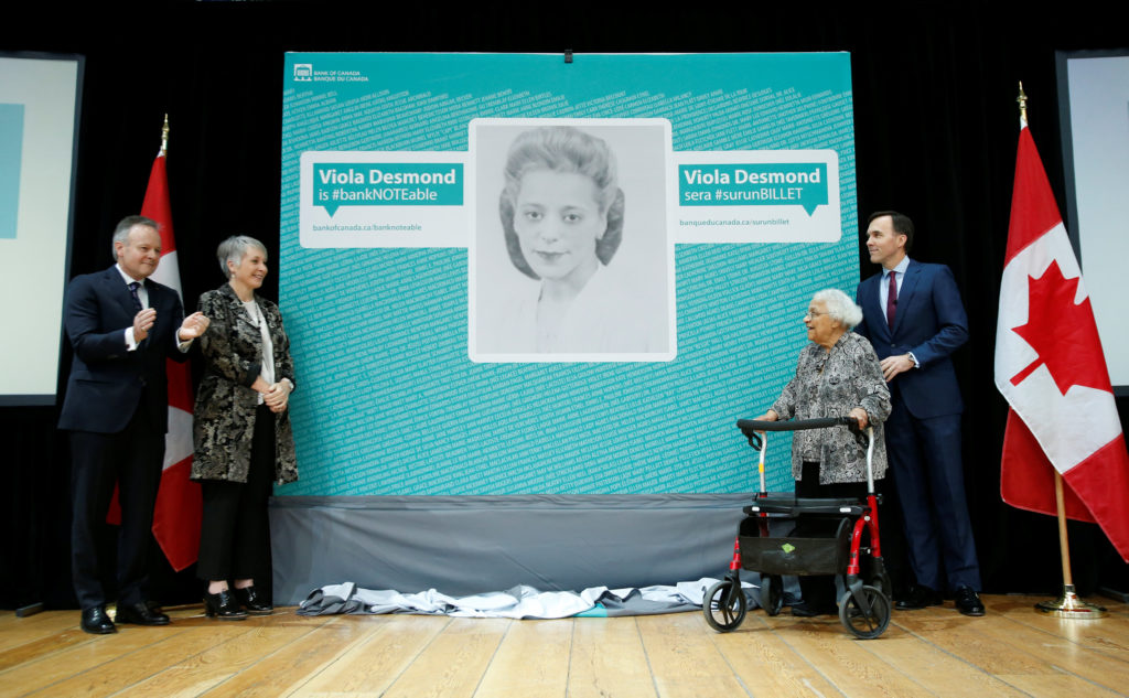 Canada's Finance Minister Bill Morneau stands with Wanda Robson after her sister Viola Desmond was chosen to be featured on a new $10 bank note during a ceremony at the Museum of History with Governor of Bank of Canada Stephen Poloz and Minister of Status of Women Patty Hajdu, in Gatineau, Quebec, Canada, December 8, 2016.  REUTERS/Chris Wattie