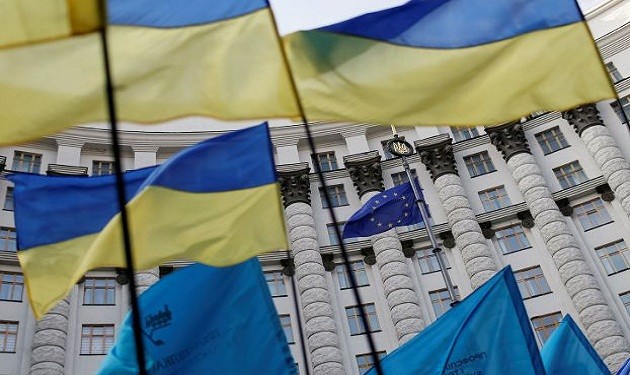 Ukrainian national flags, flags of Ukrainian trade unions and EU flag are seen during  a mass rally in front of the Ukrainian cabinet of ministers building in Kiev